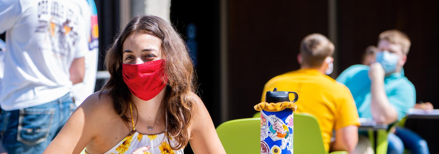 Student attending class with a mask on. 